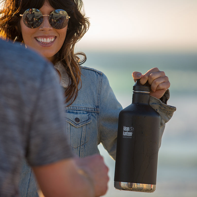 64oz-classic-with-loop-cap-s1 64oz_insulated_classic_black_beach_girl_hand_square.jpg