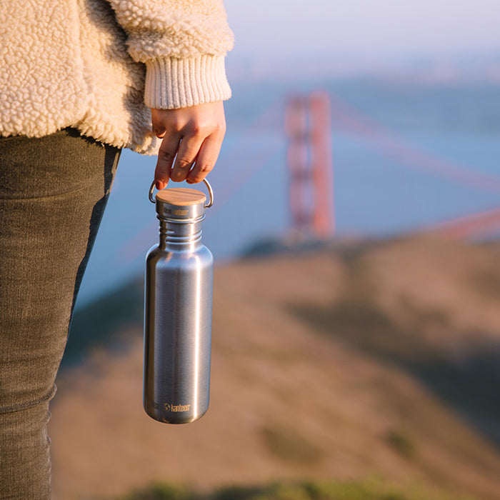 27oz-reflect-with-bamboo-cap-c9 K27SSLRF-BS-BAMBOO_reflect_bottle_bridge_lifestyle.jpg