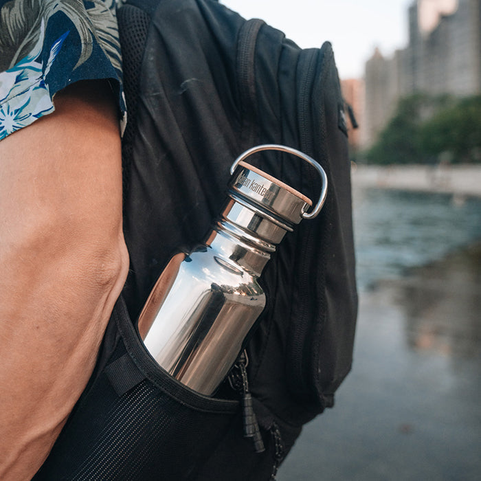 27oz-reflect-with-bamboo-cap-c9 K27SSLRF-MS-BAMBOO_reflect-bottle_backpack_lifestyle.jpg
